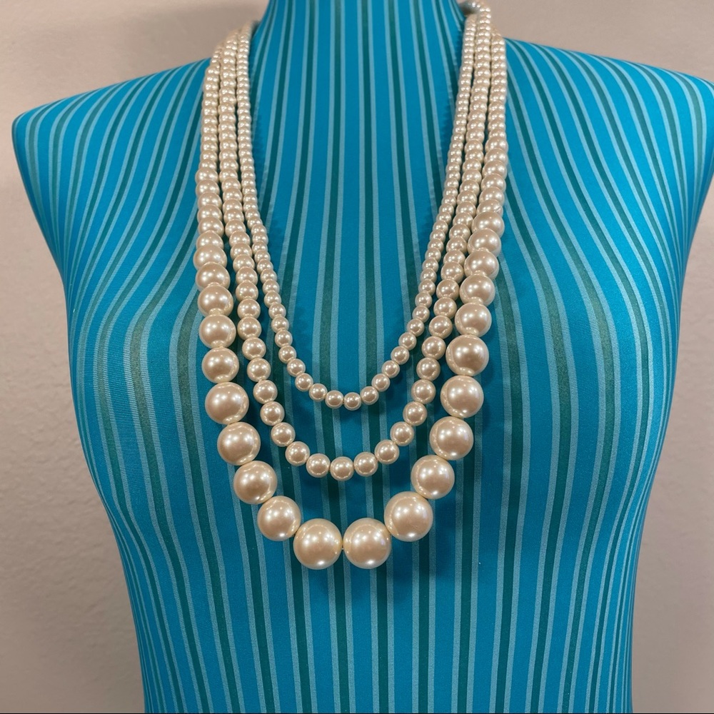 Three faux pearl strands with black ribbon tie